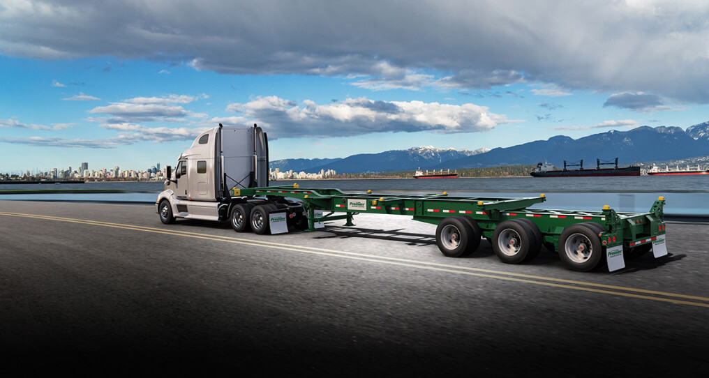 Premier chassis driving down a scenic road on a sunny day