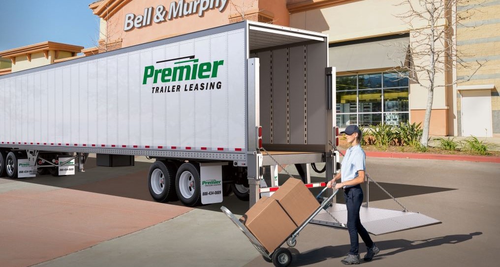 Driver unloading boxes from a premier truck