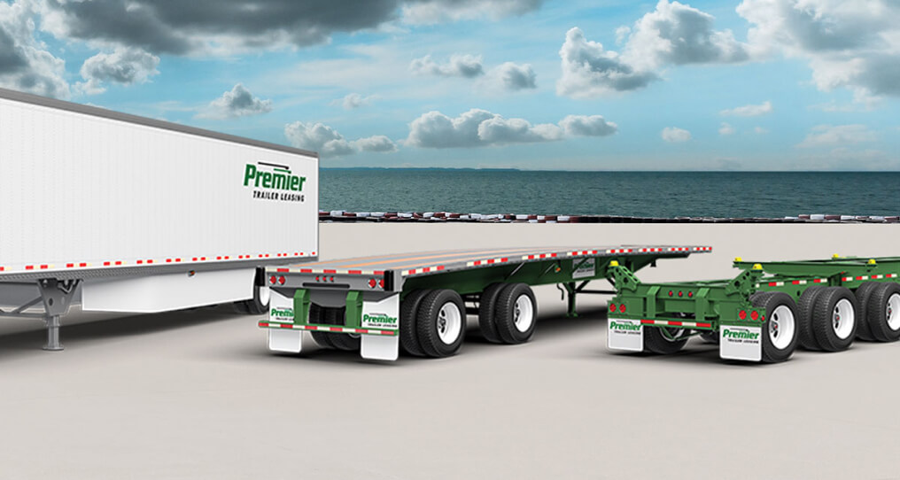 Premier trailer, flatbed , and chassis parked next to each other