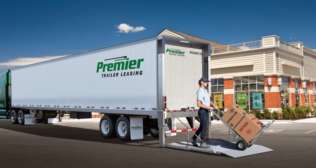 Driver unloading boxes from a premier truck